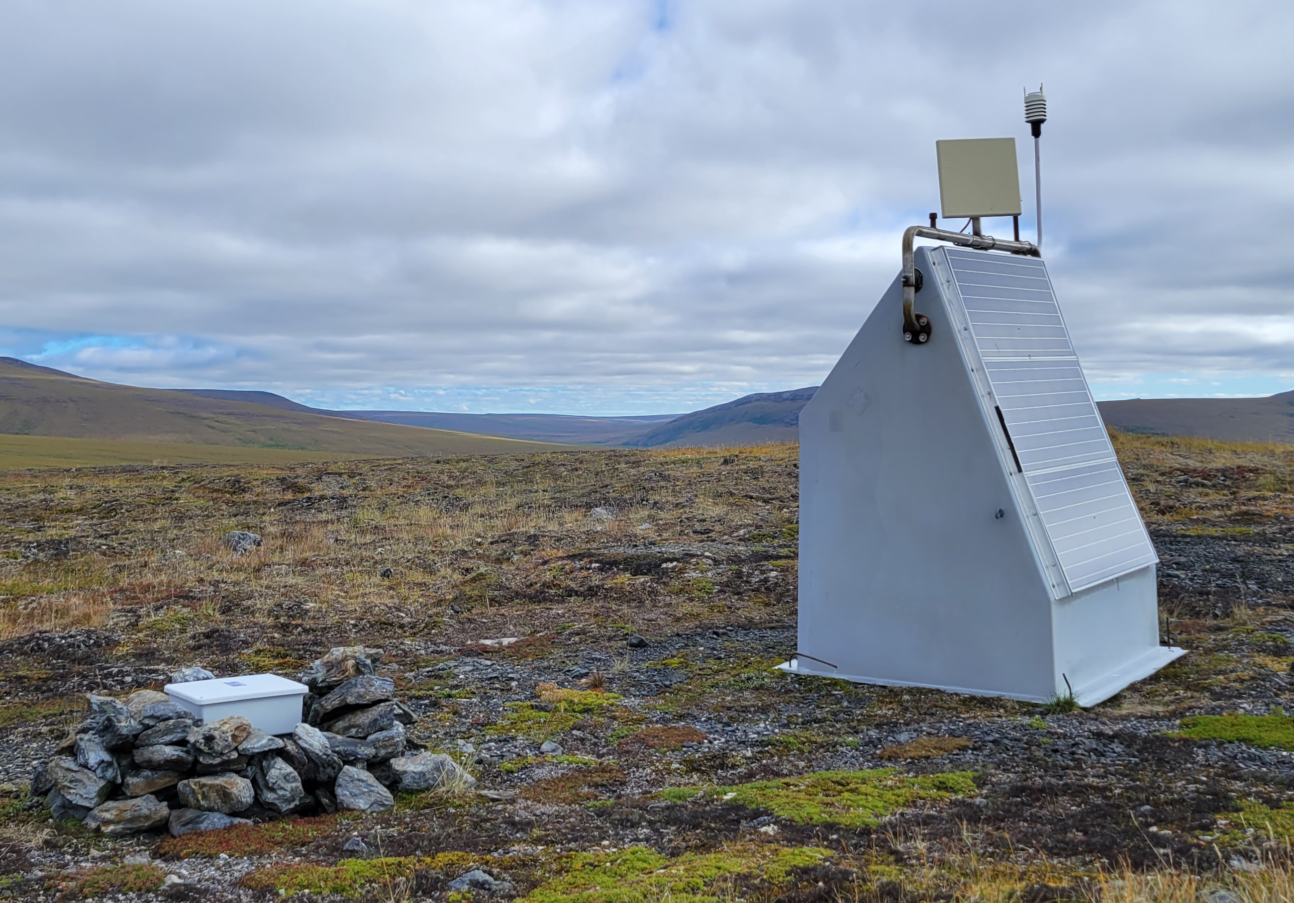 Station hut with square satellite antenna.