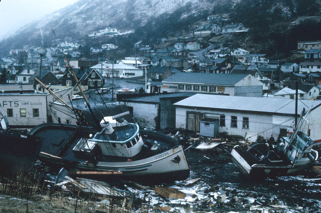 Tsunami damage showing boats thrown on shore near buildings.