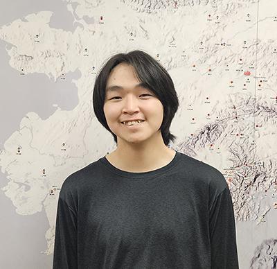 Young man in front of map of Alaska